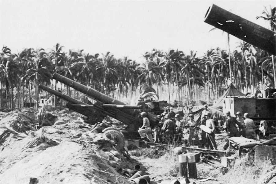 Photo of large artillery guns in a jungle pointing into the sky