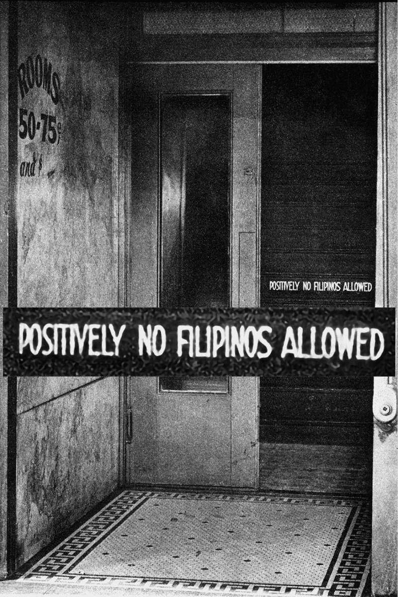 Black and white photo of a doorway with a sign reading, 
