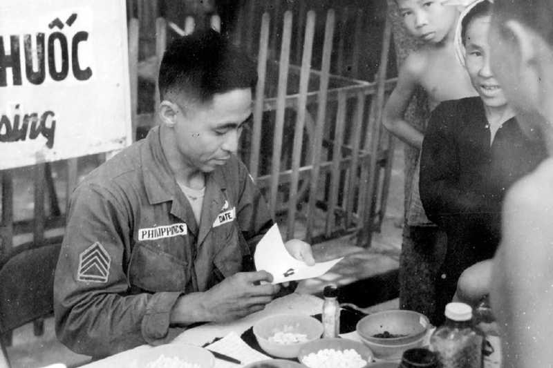 soldier gives medical supplies to a civilian 