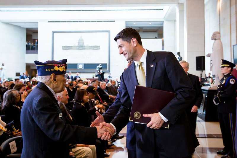 Celestino Almeda, veteran, shaking hands with Paul Ryan