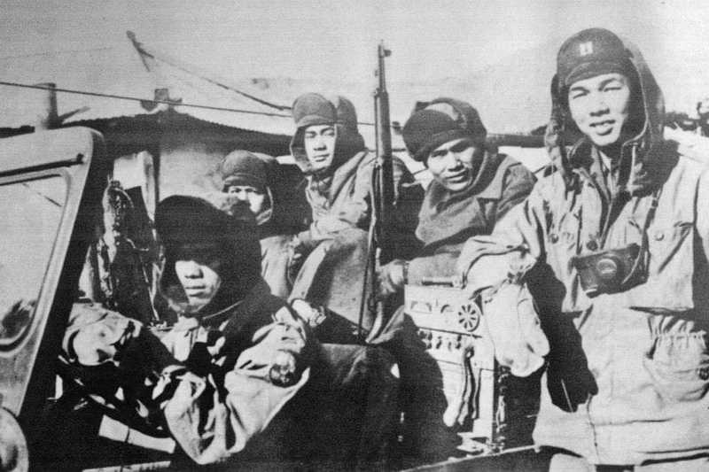 Filipino soldiers in a jeep with guns