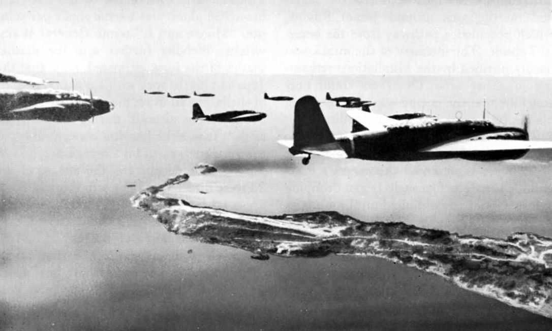 Photo of fleet of Japanese planes flying over an island