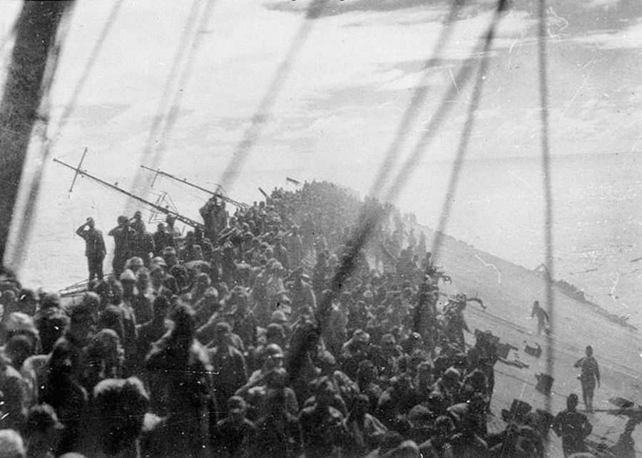 Photo showing the side of a sinking ship crowded with Japanese soldiers