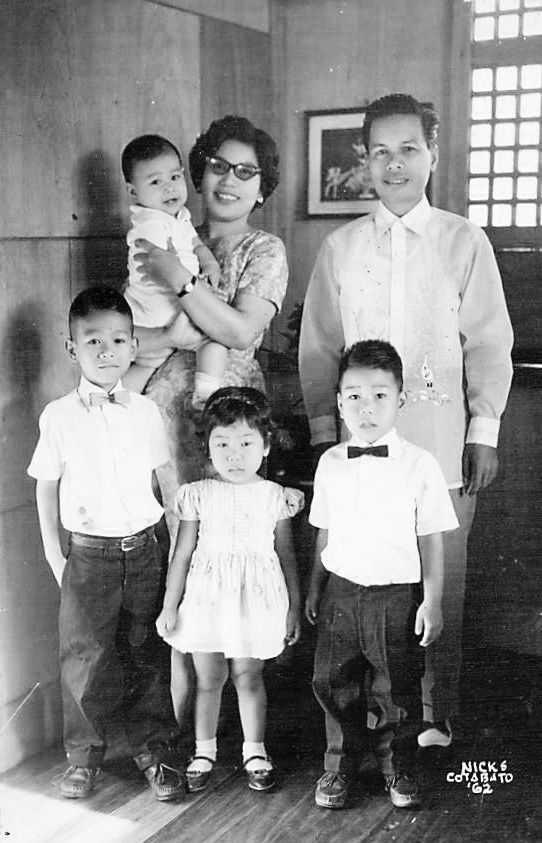 Photo of Filipino family posing in semi-formal dress.