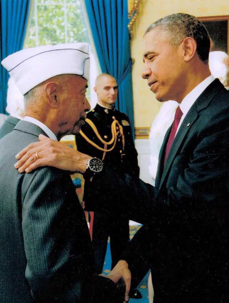 President Obama shakes the hand of veteran Jesse Baltazar