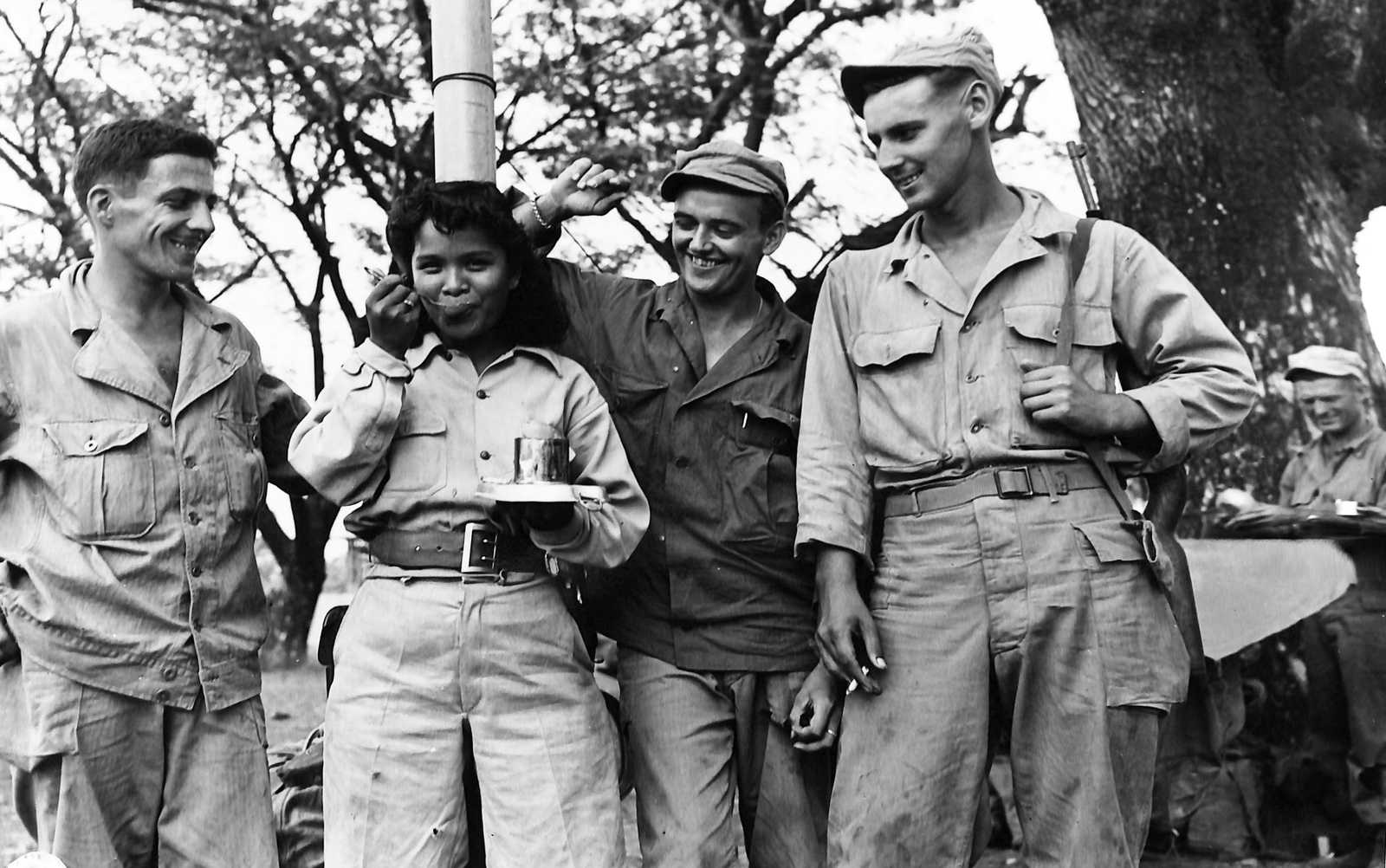 Photo of American soldiers and Filipina guerrilla laughing