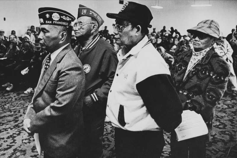 Veterans standing at a forum